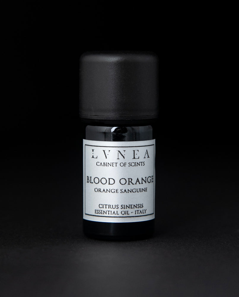 5ml black glass bottle of LVNEA's blood orange essential oil on black background. The bottle has a silver label.