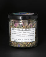 Clear glass jar with black screw top lid containing blueberryjams' "Ariadne's Blessing" herbal tea blend