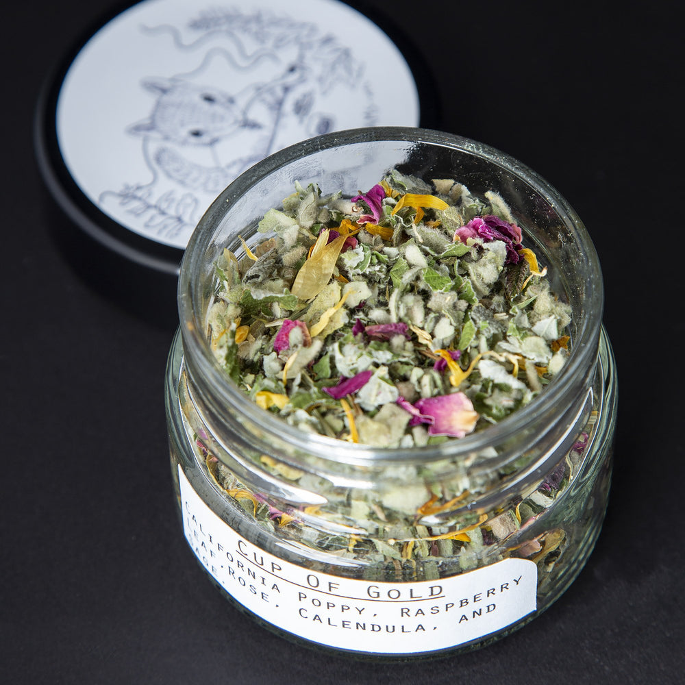 Open glass jar revealing the dried herbal rolling blend within.