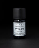 5ml black glass bottle with silver label of LVNEA's cypress essential oil on black background