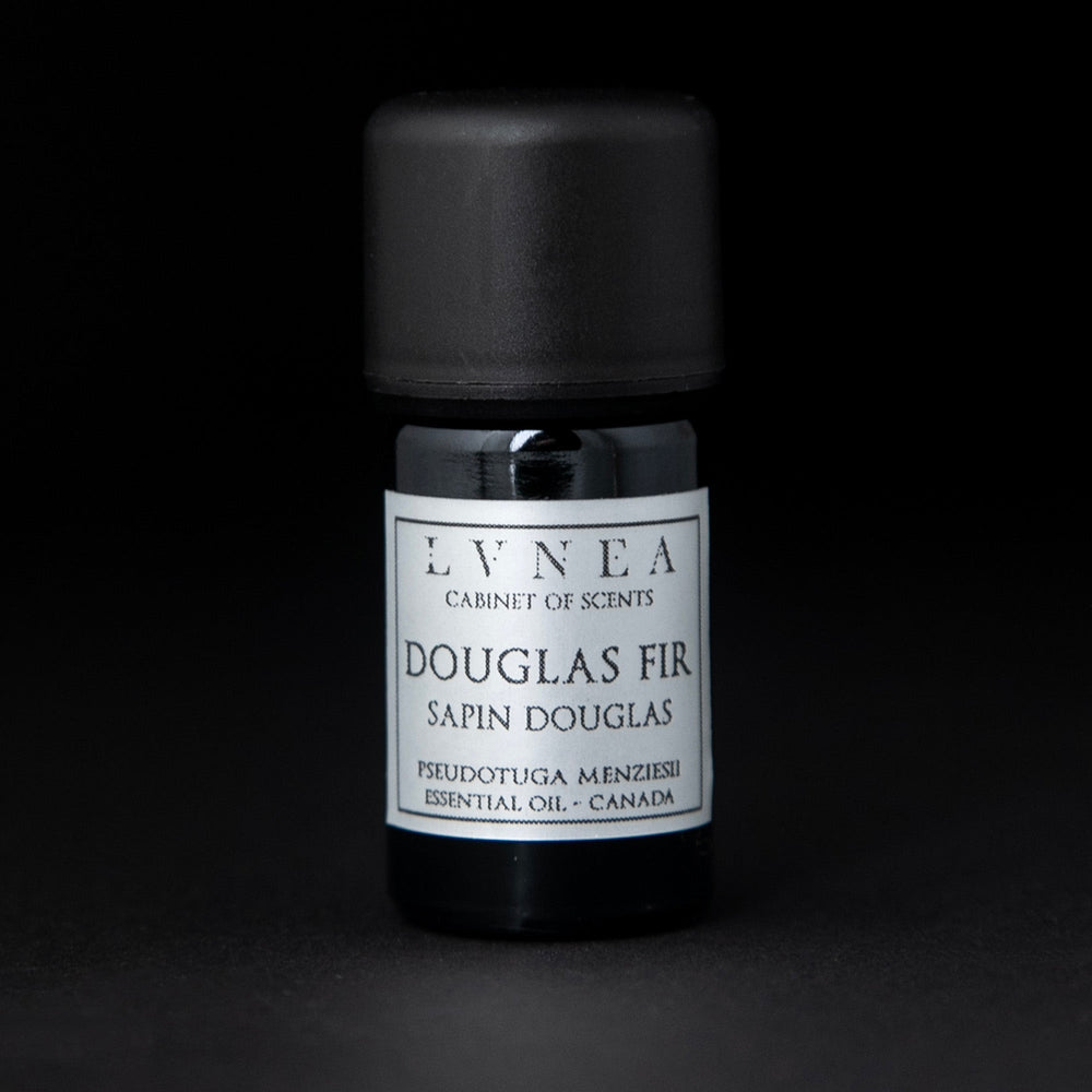 
                      
                        5ml black glass bottle with silver label of LVNEA's douglas fir essential oil on black background
                      
                    