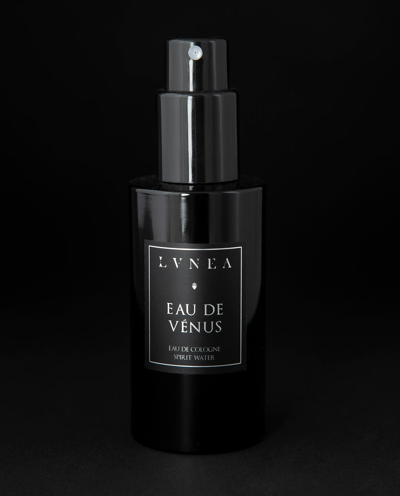 100ml black glass bottle of LVNEA’s Eau de Venus natural fragrance on black background
