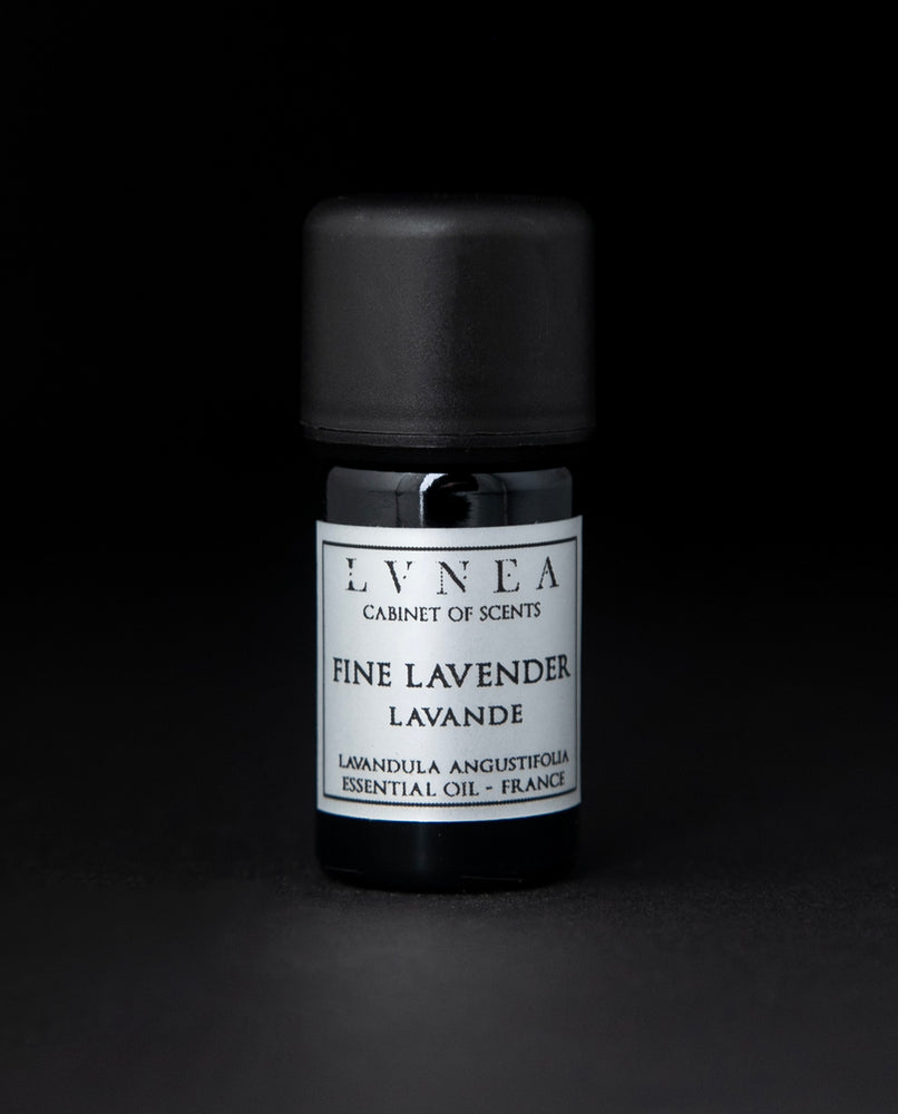 5ml black glass bottle of LVNEA's lavender essential oil on black background. The label on the bottle is silver.