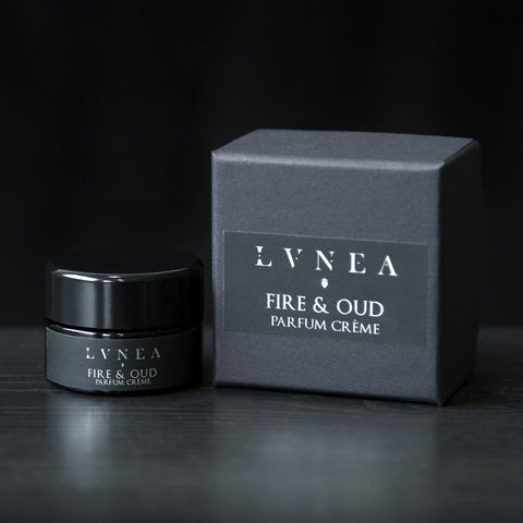 10g black glass jar of LVNEA's Fire & Oud solid perfume and its box on black background