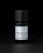 5ml black glass bottle of LVNEA's ginger lily essential oil on black background