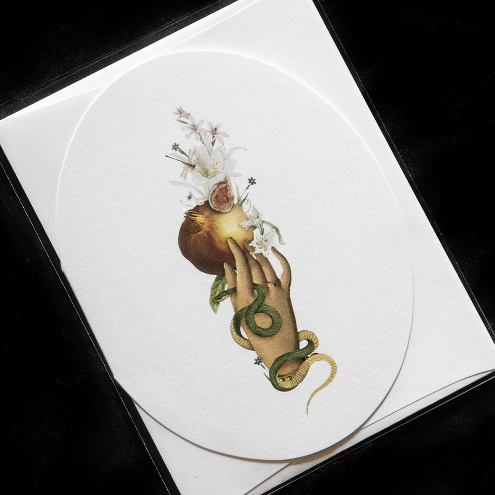 white oval greeting card with victorian-style illustration of a hand holding a pomegranate
