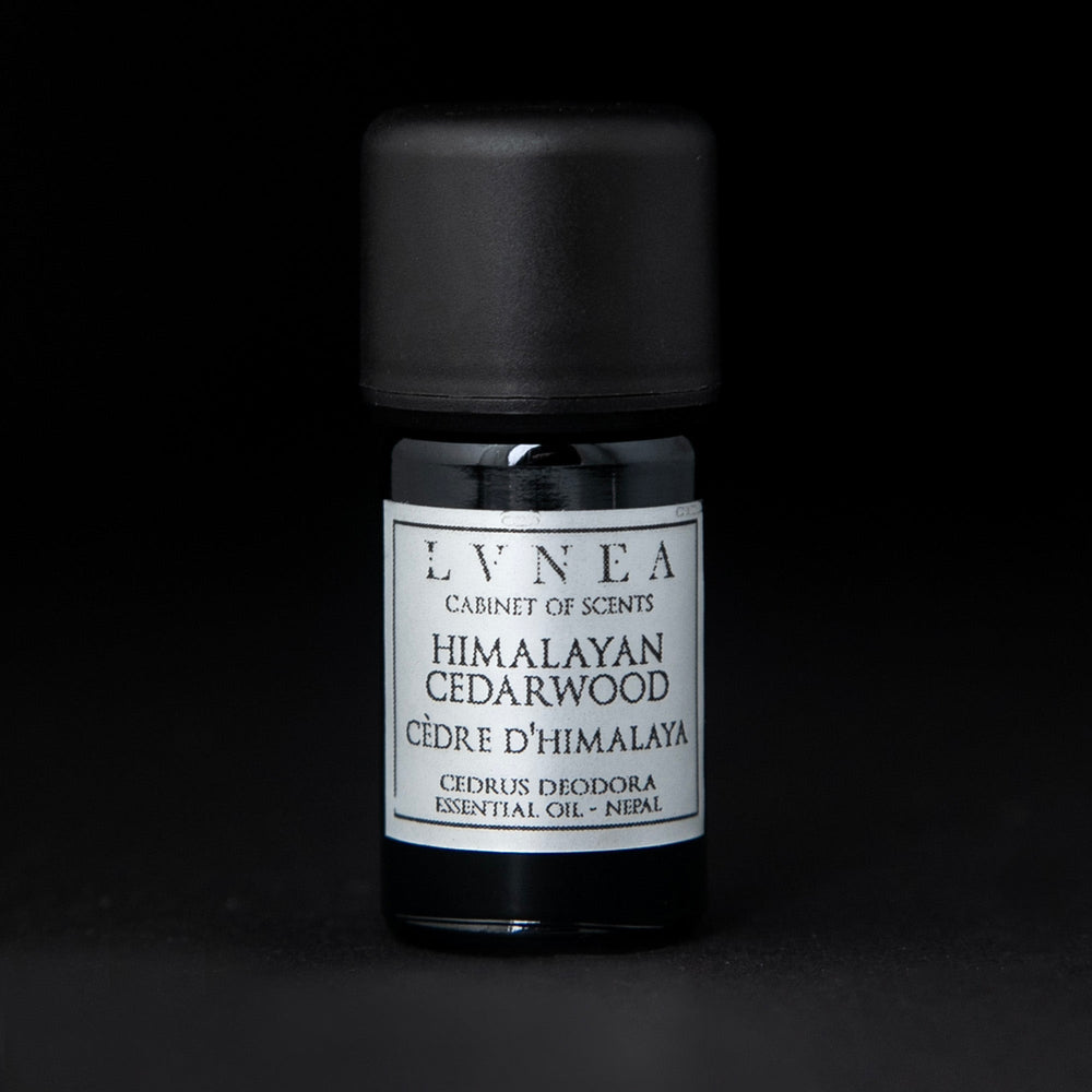 5ml black glass bottle with silver label of LVNEA's himalayan cedarwood essential oil on black background