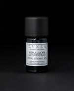 5ml black glass bottle with silver label of LVNEA's himalayan cedarwood essential oil on black background