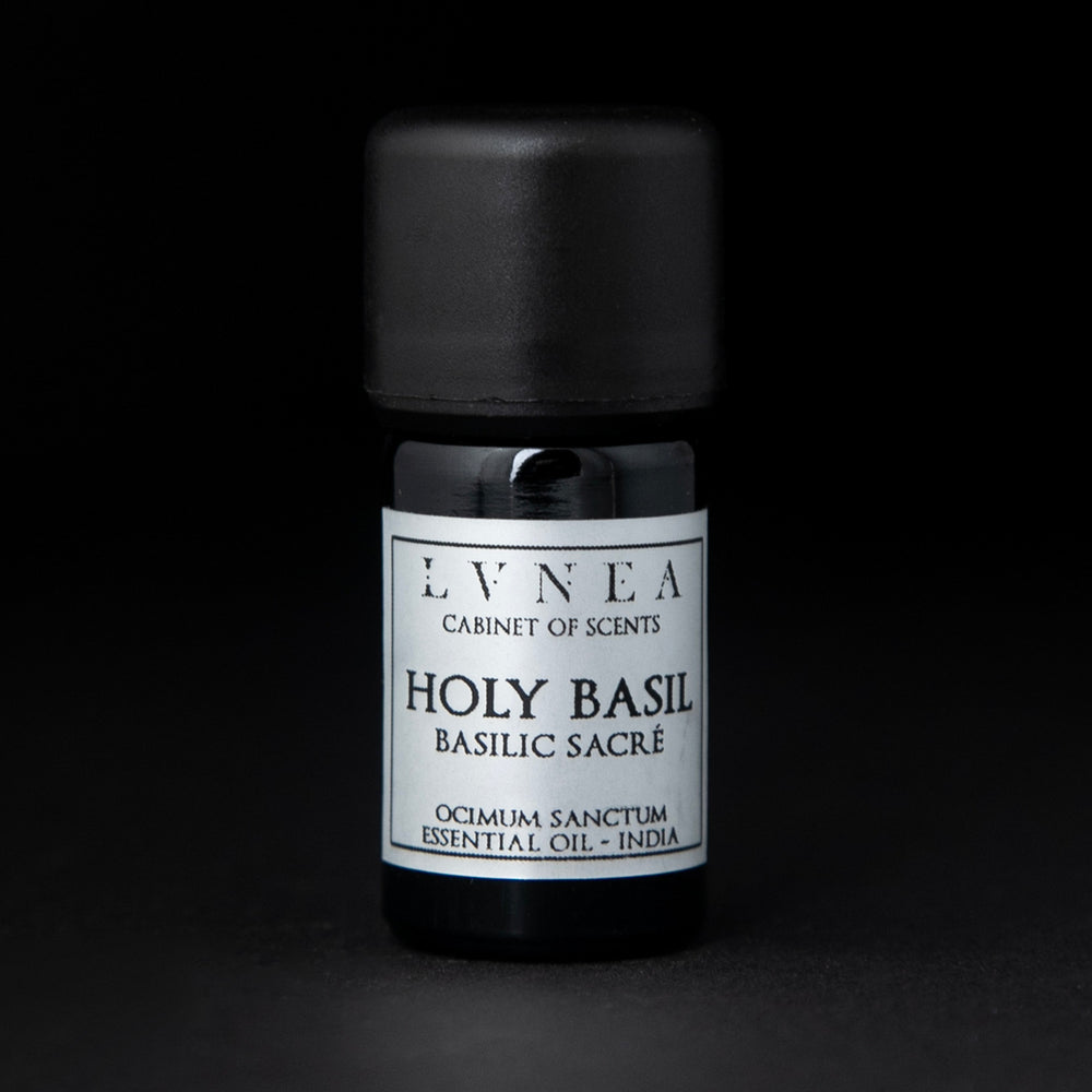 5ml black glass bottle of LVNEA's holy basil essential oil on black background. The label on the bottle is silver.