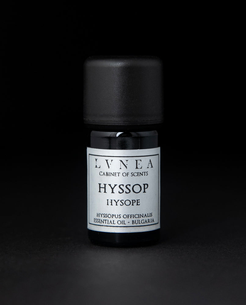 5ml black glass bottle of LVNEA's hyssop essential oil on black background. The label on the bottle is silver.