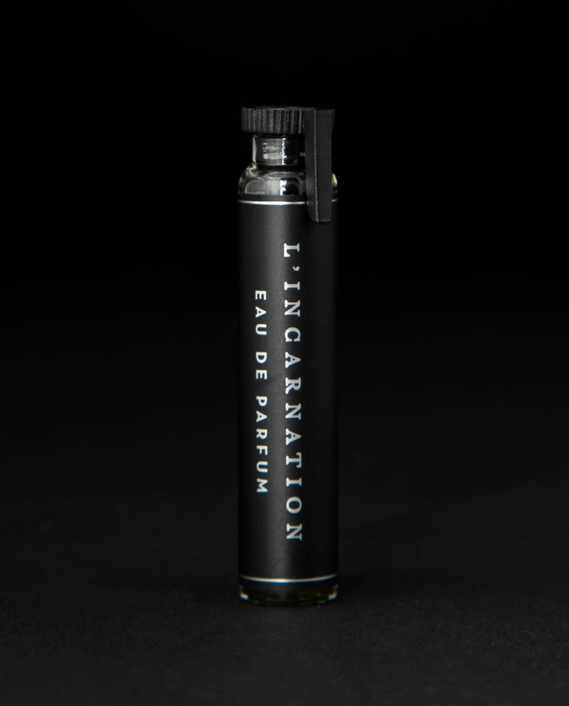 2ml glass sample vial of LVNEA's l'Incarnation natural perfume on black background