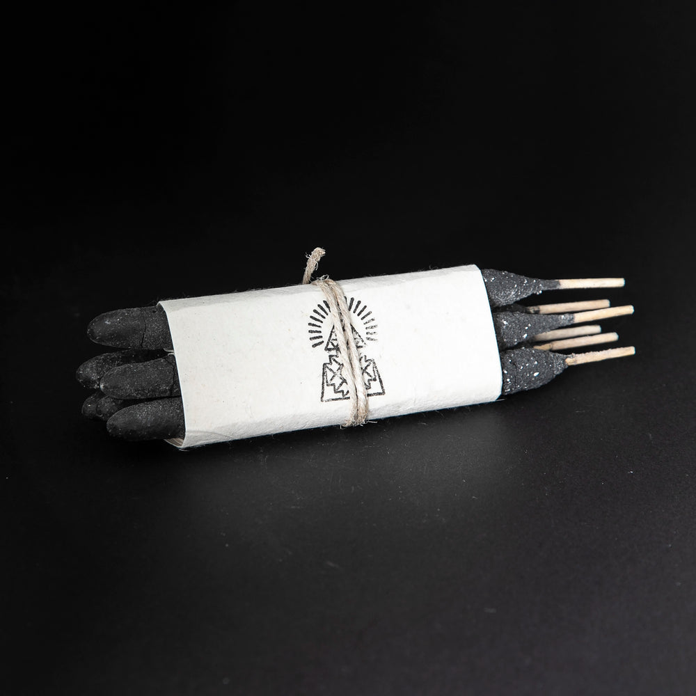 
                      
                        one bundle of Incausa's hand-rolled pure breu incense wrapped in white paper and twine, on a black background
                      
                    