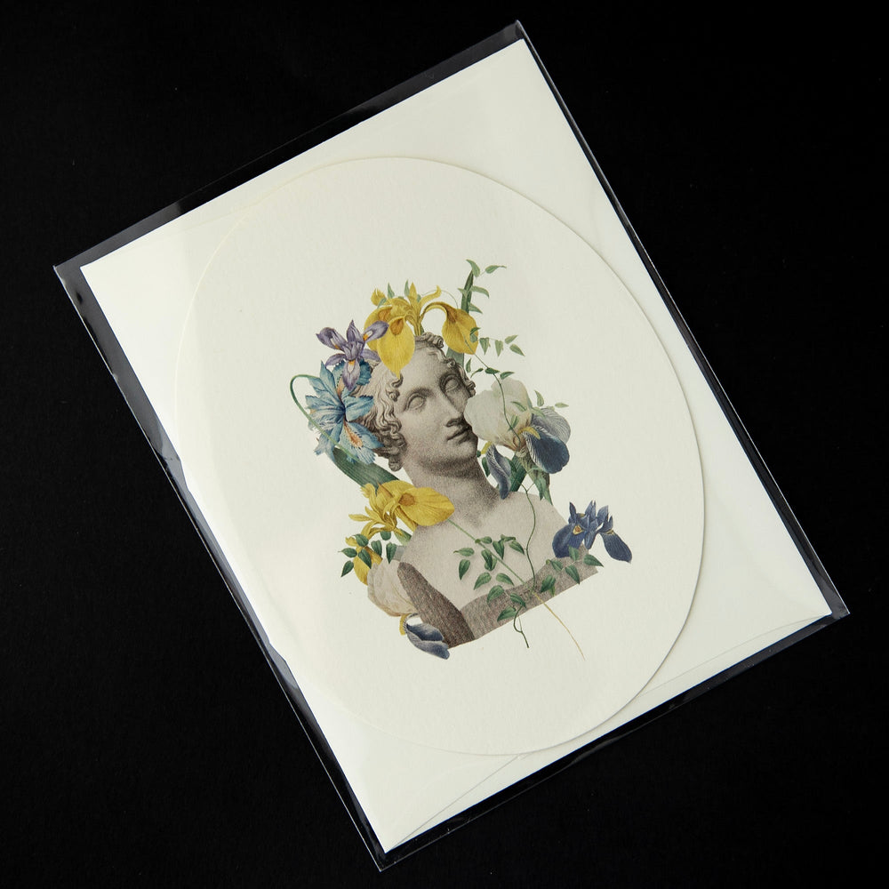White oval-shaped card featuring a vintage Victorian-style illustration of a marble bust surrounded by irises.