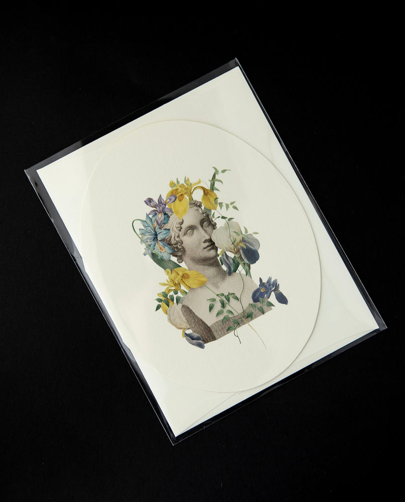 White oval-shaped card  featuring a vintage Victorian-style illustration of a marble bust surrounded by irises.