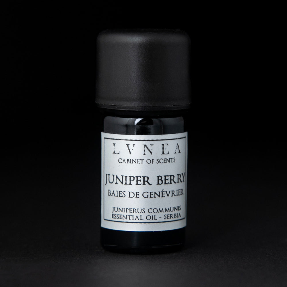5ml black glass bottle of LVNEA's juniper berry essential oil on black background. The label on the bottle is silver.