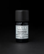 5ml black glass bottle of LVNEA's lavender absolute on black background. The label on the bottle is silver.