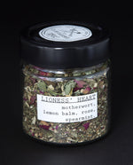 Clear glass jar filled with a herbal tea blend by blueberryjams.