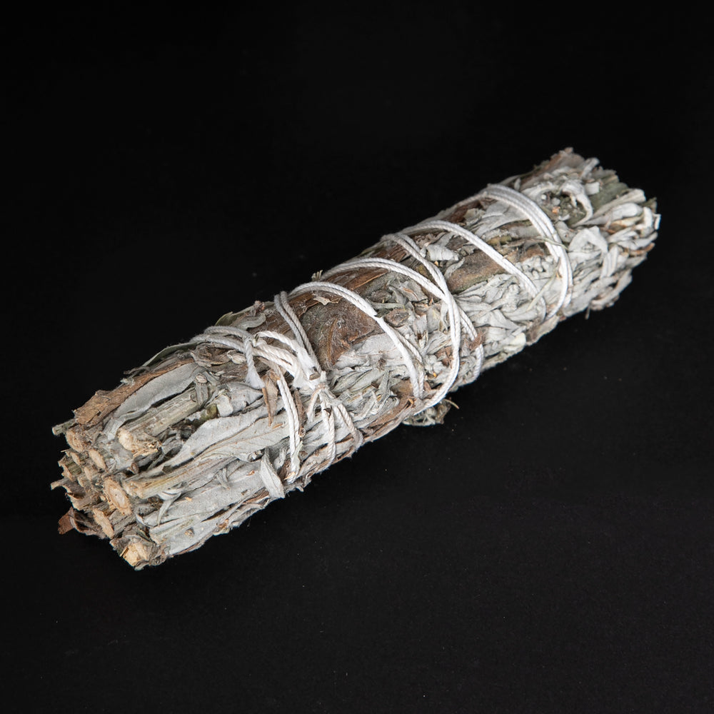 
                      
                        bundle of dried mugwort wrapped in white string on black background.
                      
                    