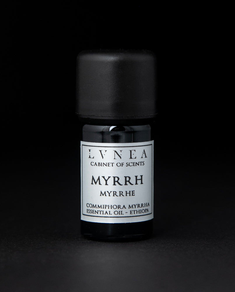 5ml black glass bottle of LVNEA's myrrh essential oil on black background. The label on the bottle is silver.