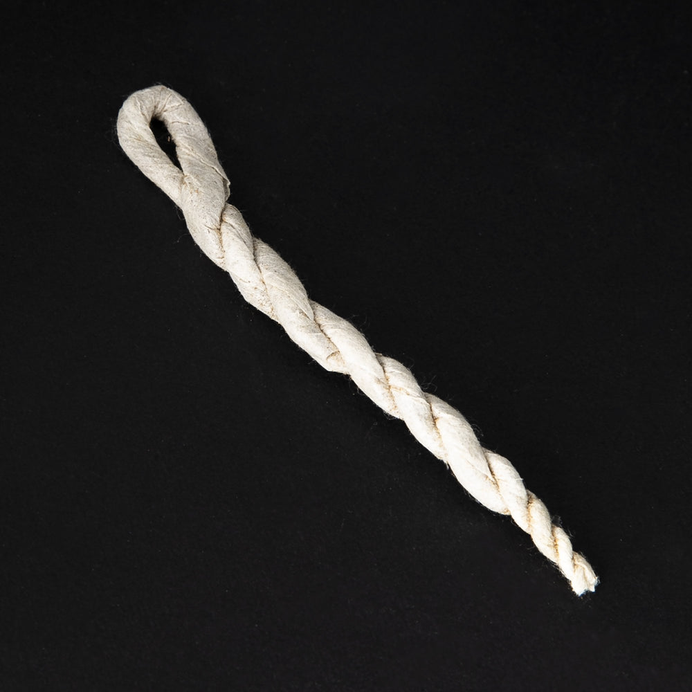 
                      
                        A single unit of rope incense on a black background. Each piece consists of botanical material wrapped in paper and twisted.
                      
                    