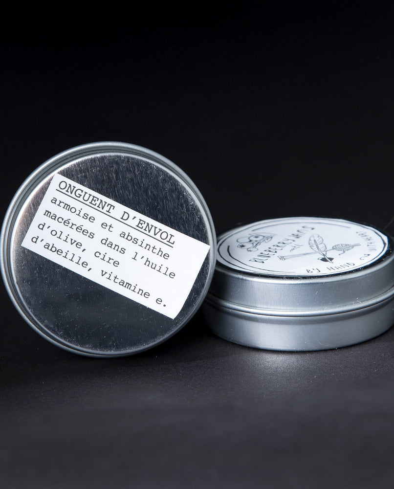two tins of blueberryjams' flying ointment herbal salve nestled up against each other. 
