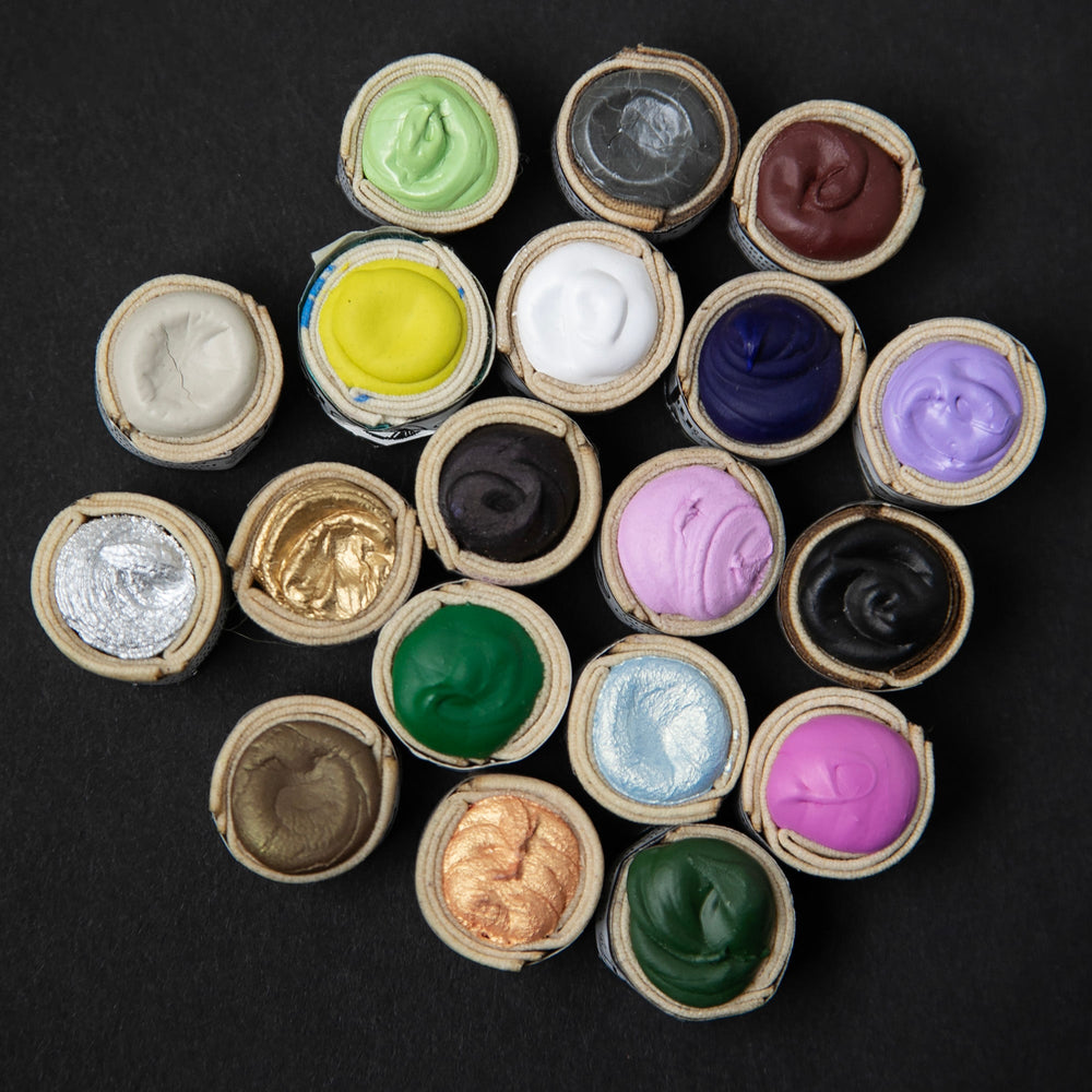
                      
                        A colourful array of Beam Paints' watercolour paintstones against a black background.
                      
                    