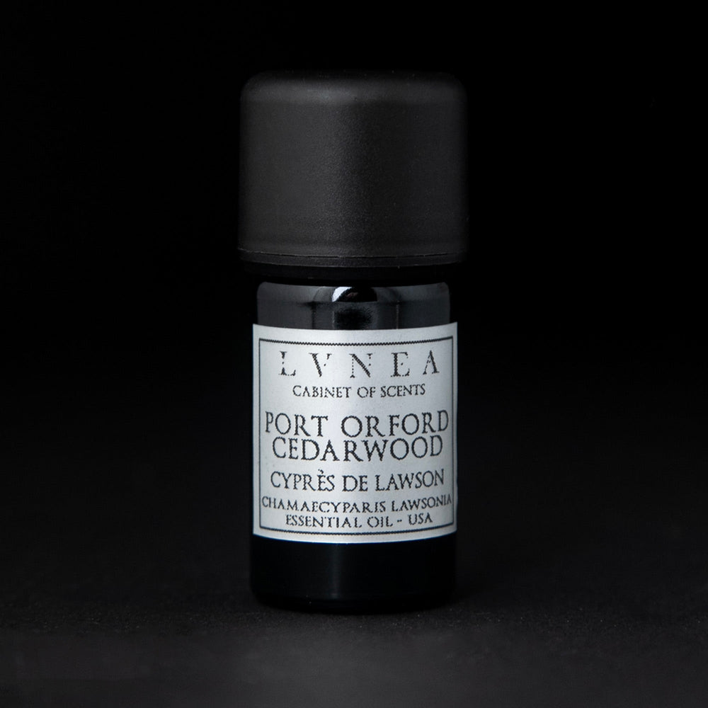 5ml black glass bottle with silver label of LVNEA's Port Orford cedarwood essential oil on black background