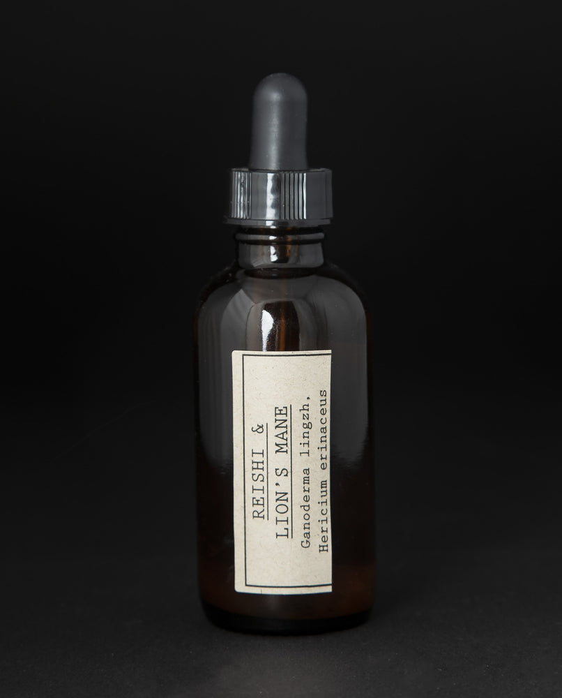 Amber glass bottle with dropper top filled with blueberryjams' "Reishi & Lion's Mane" herbal tincture