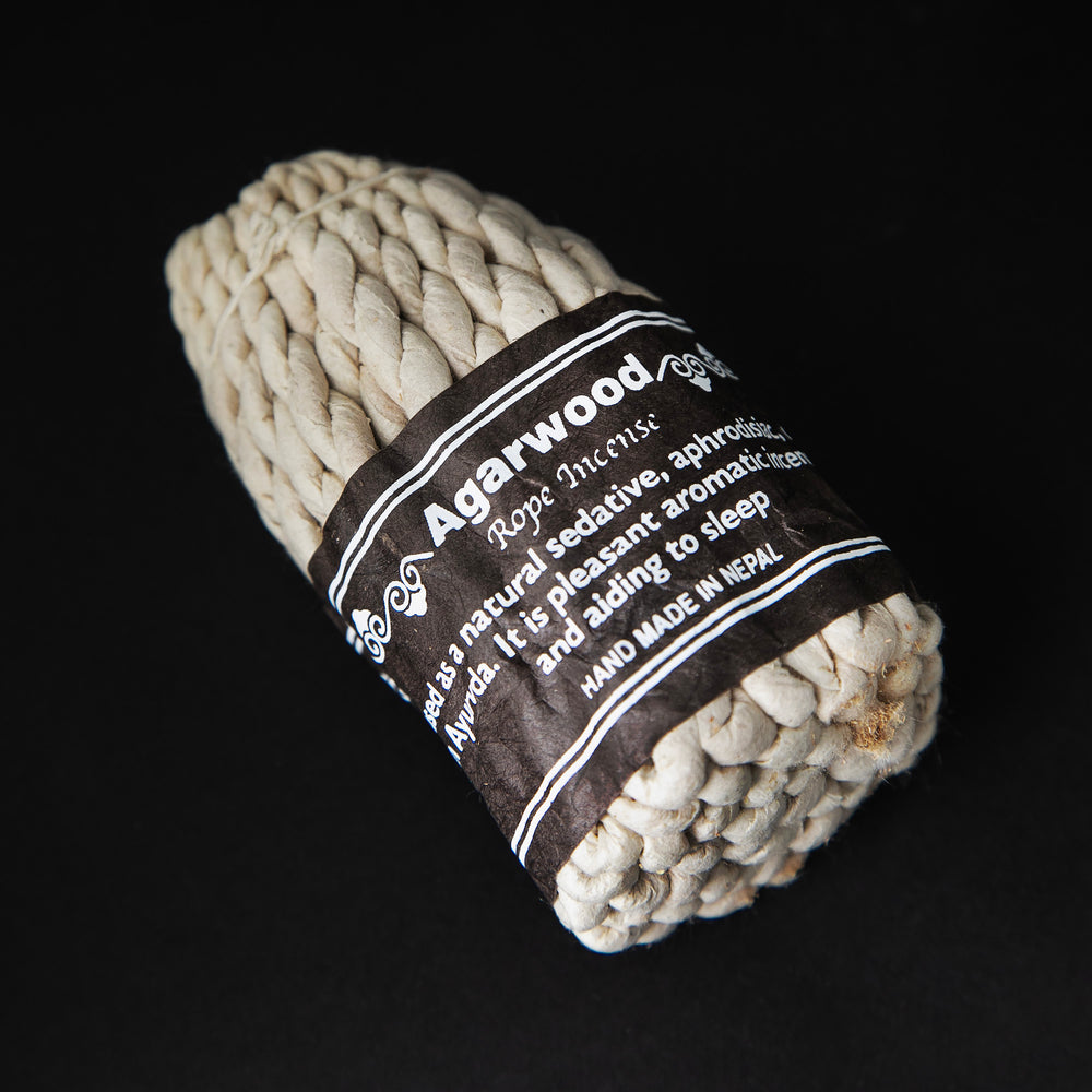 
                      
                        Bundle of agarwood rope incense wrapped together with brown paper label.
                      
                    