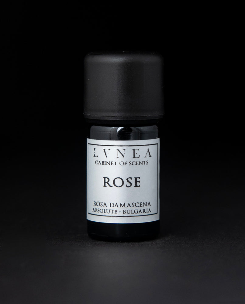 5ml black glass bottle of LVNEA's rose absolute on black background. The label on the bottle is silver.