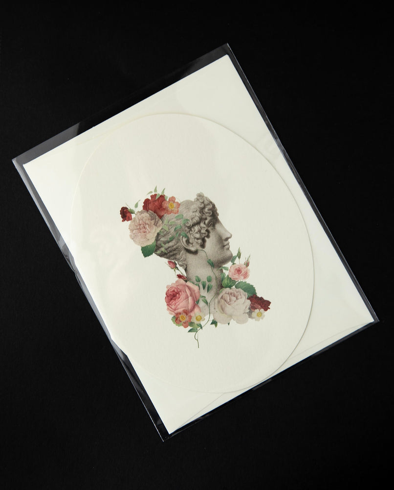 white oval-shaped greeting card with a vintage Victorian-style illustration of a marble bust surrounded by roses