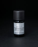 5ml black glass botttle of LVNEA's sandalwood bioabsolute on black background. The label on the bottle is silver.