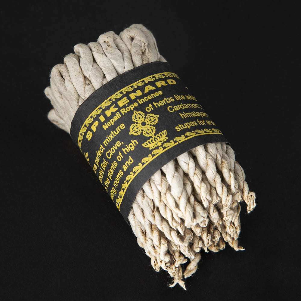 
                      
                        Bundle of spikenard rope incense wrapped together with black paper label.
                      
                    
