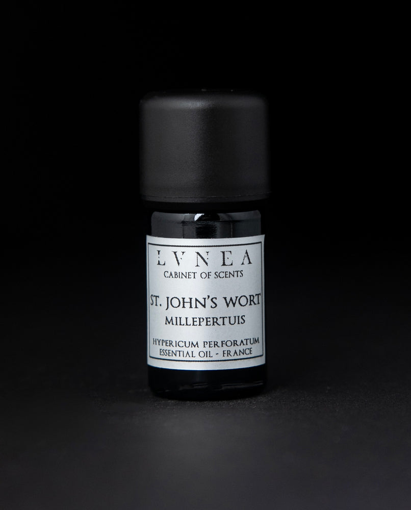 5ml black glass bottle of LVNEA's St. John's Wort essential oil on black background. The label on the bottle is silver.