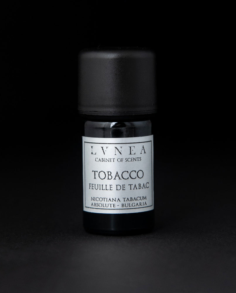 5ml black glass bottle of LVNEA's tobacco absolute on black background. The label on the bottle is silver.