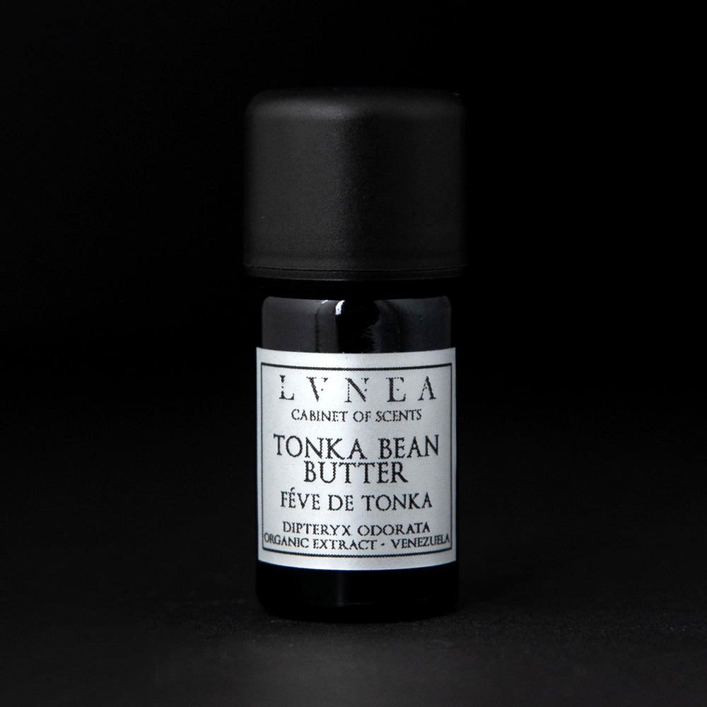 5ml black glass bottle of LVNEA's tonka bean butter on black background. The label on the bottle is silver.