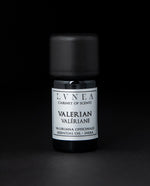5ml black glass bottle of LVNEA's valerian essential oil on black background. The label on the bottle is silver.
