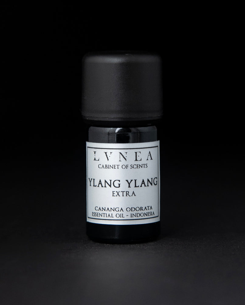 5ml black glass bottle of LVNEA's ylang ylang essential oil on black background. The label on the bottle is silver.